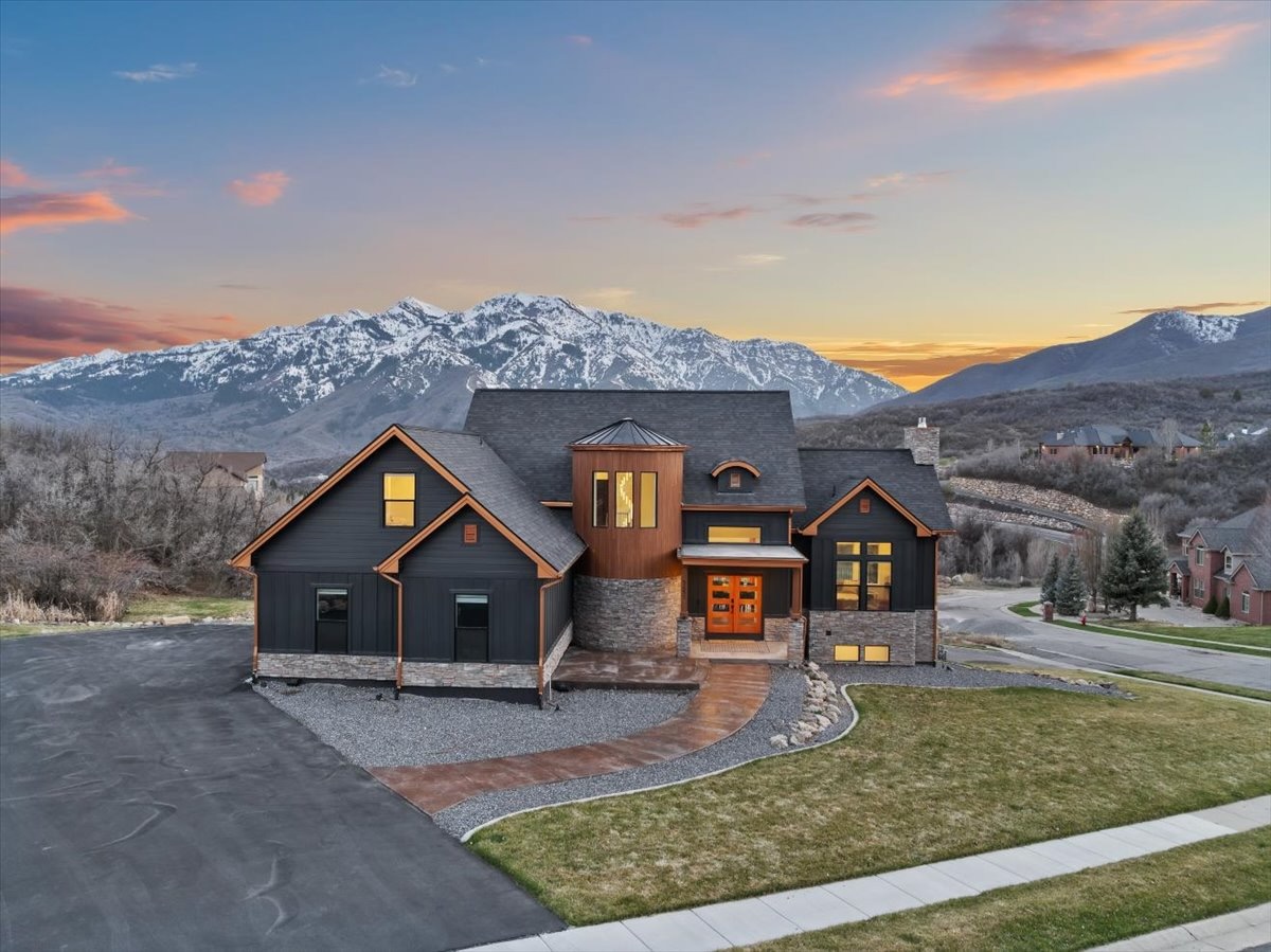 Custom mountain home with sunset and snow-capped peaks